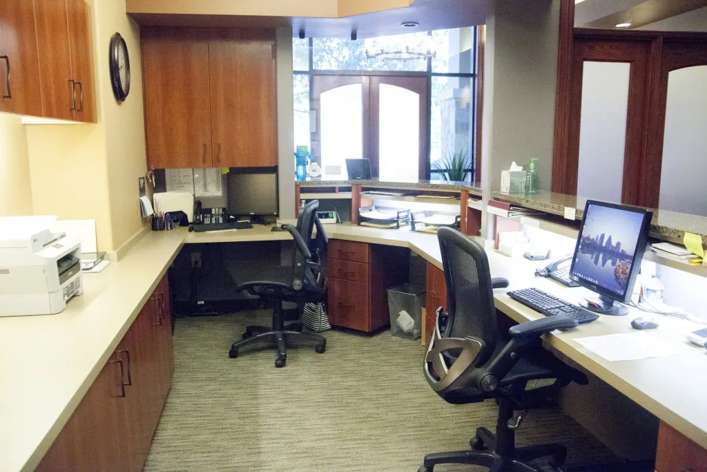 Reception area showing computers and chairs at {PRACTICE_NAME}